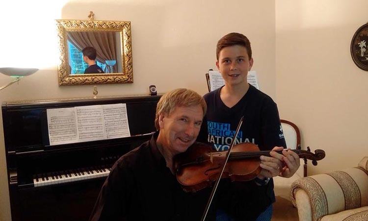 Getting first violin lesson from talented young musician andrew gilbert. Not for sensitive ears!