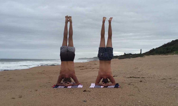 Early morning father and son headstands at Blythedale to relieve tension.
